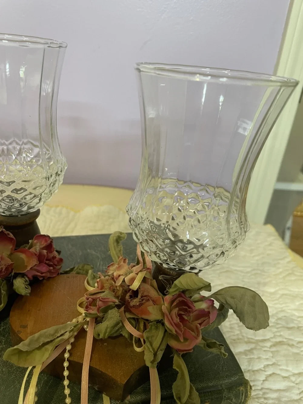 Pair of Vintage Clear Glass Hurricane Candle Holders with Floral Accents on wood